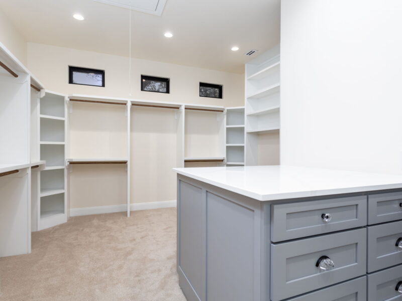 Walk-in closet with built-in shelves and island