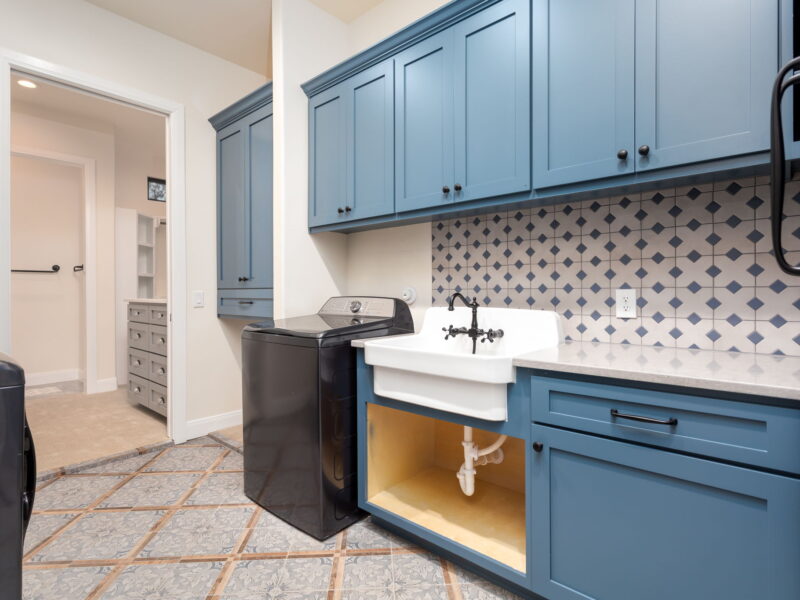 Laundry room with blue cabinets and farmhouse sink