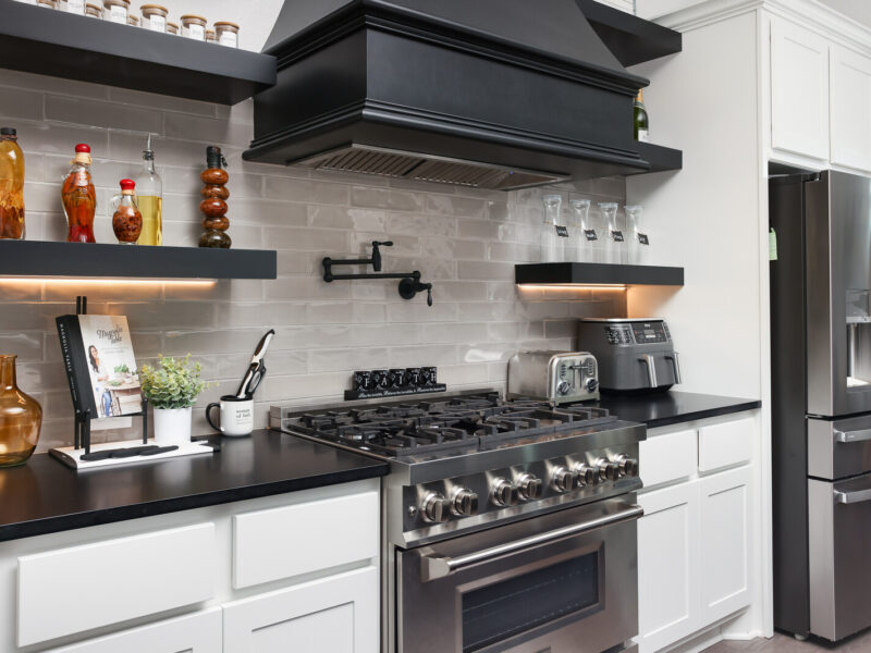 Close view of the kitchen range hood and open shelves