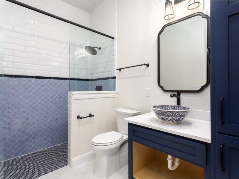 Bathroom with glass shower and blue tile