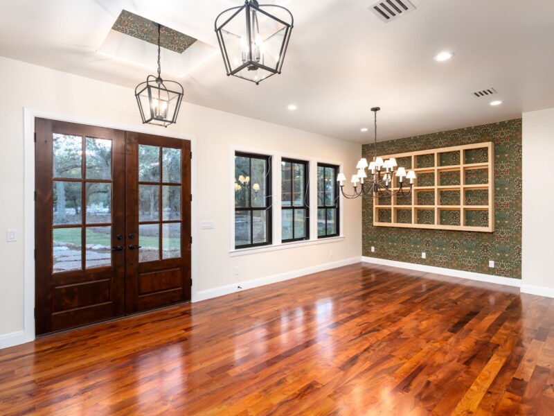 Dining room with wood doors and pendant lights