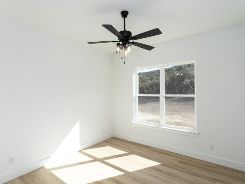 Bedroom with a ceiling fan and window