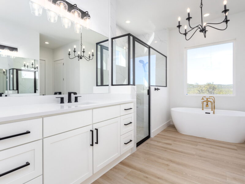 Primary bathroom with double vanity, glass shower and freestanding tub