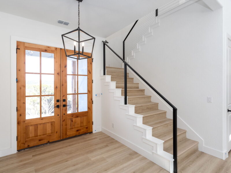 Wood front doors and staircase inside The Peak
