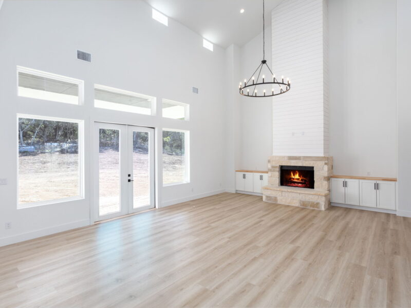 Living room with a fireplace and doors to the outdoors