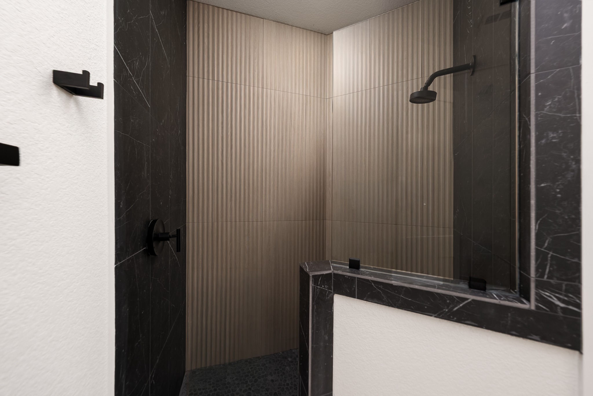 Bathroom shower with contrasting stone tile