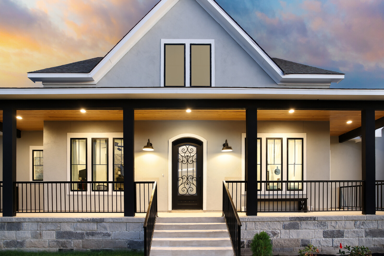 Front porch and entry of a Macaw Homes custom home at sunset